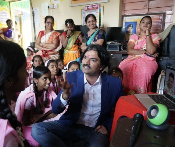 Santosh Talaghatti engaging with students and families as part of the Smart Villages and Smart Schools initiative in rural India