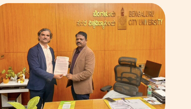 Santosh Talaghatti signing a partnership agreement with Bengaluru City University